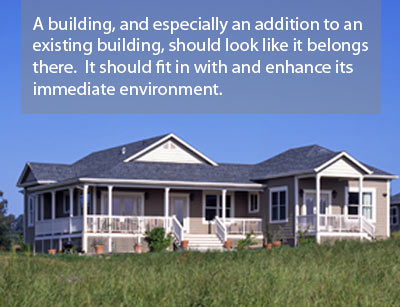 A building, and especially an addition to an existing building, should look like it belongs there.  It should fit in with and enhance its immediate environment.